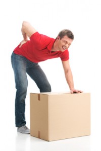 man dressed in casual clothing hurt his back lifting large box. young man suffering from back pain isolated on white background